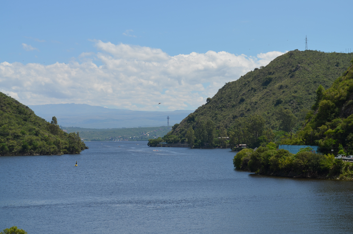 San Roque Lake with cities and mountains in the background